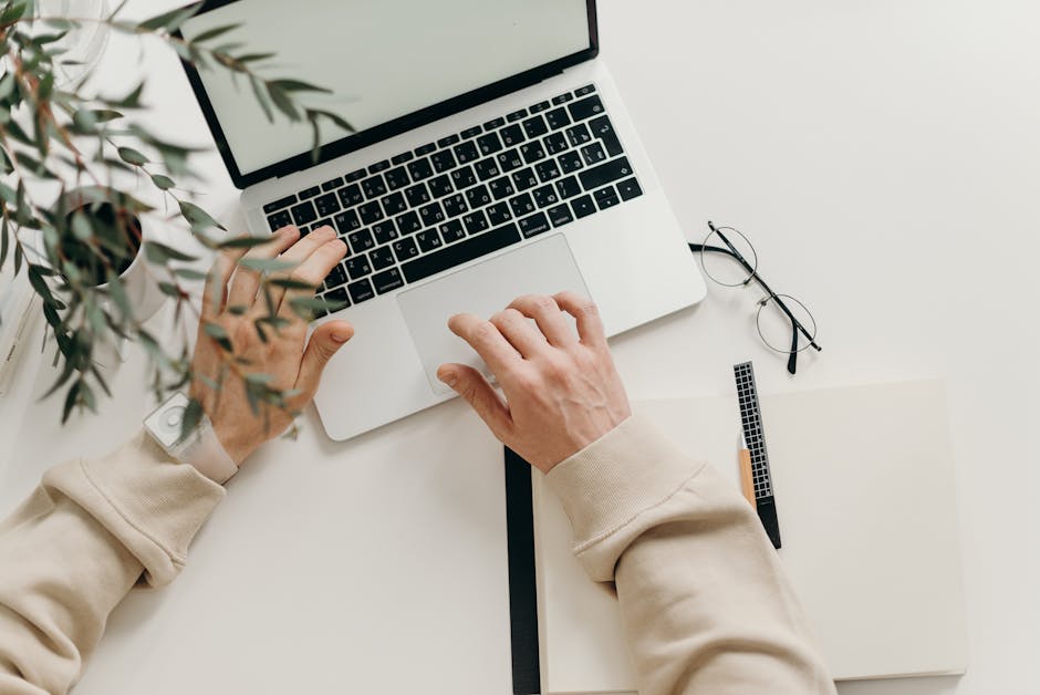 pexels-photo-4065876-4065876 An overhead view of a person working on a laptop in a minimalist home office setting.